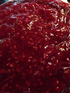 a pie is covered with cranberry sauce on the table