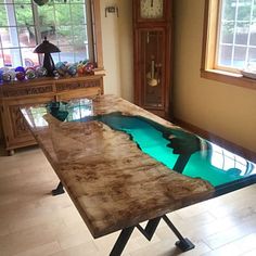 a table that has been made to look like an underwater pool in the middle of a room