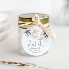 a glass jar with a label that says, thank you among the baby shower items