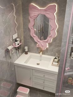 the bathroom is decorated in pink and grey