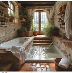 a bathroom with a large jacuzzi tub next to a stone wall and windows