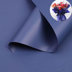 a blue wrapping paper with a bouquet of flowers on it