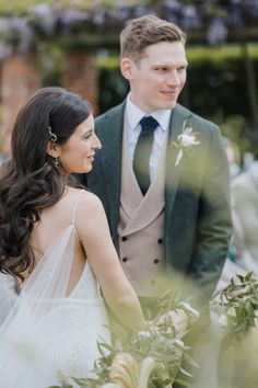 a bride and groom standing next to each other