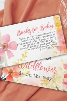 two pink and yellow flowers are on top of an orange sheet with the words books for baby