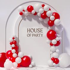 red and white balloon arch with house of party sign