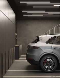 an suv parked in a parking garage with stairs leading up to the top floor and doors open