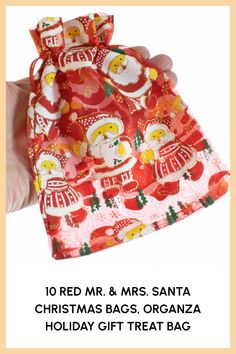 a hand holding a small bag with santa claus on it