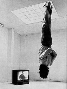 a man is upside down on the floor in front of a tv