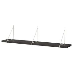 three black shelves with white poles on them