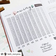 an open planner with the words savings on it next to a cross and other items