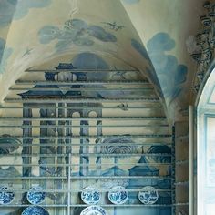 blue and white plates on shelves in a room