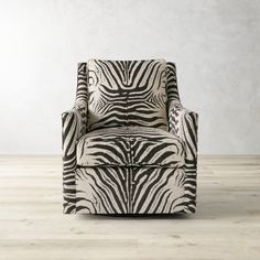 a zebra print chair sitting on top of a hard wood floor