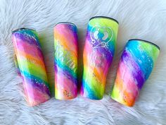 three different colored lighters sitting on top of a white fur covered floor next to each other