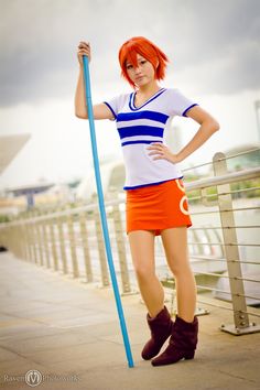 a woman with red hair is holding a pole