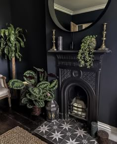 a living room with a fire place, mirror and potted plants on the mantle