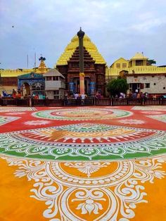 an intricately painted floor in front of a temple