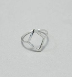 Rhombus ring, hollow, sterling silver, minimalist, geometrical, modern ring This rhombus ring is made to order from sterling silver wire. A comfortable minimalistic ring that you can wear every day. Height of rhombus: approx. 1,2 cm This ring is made to order; please make sure you choose your size. Convo me if your size is not available. Feel free to ask me if you don't know which is the right size for you. The ring above is not the exact one you will receive. Each one is handmade to order and m Minimalist Silver Stackable Rings With Diamond Cut, Modern Diamond-shaped Promise Ring, Sterling Silver Diamond-shaped Rings, Silver Sterling Silver Diamond-shaped Rings, Diamond-shaped Sterling Silver Rings, Sterling Silver Rings In Diamond Shape, Silver Sterling Silver Diamond Rings, Minimalist Silver Geometric Jewelry, Silver Geometric Sterling Silver Ring