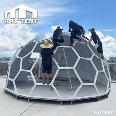 three men working on the roof of a building with an open hexagonal structure