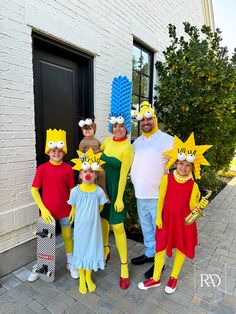 a group of people in costumes posing for a photo