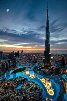 an aerial view of the burj tower in dubai at night with lights on