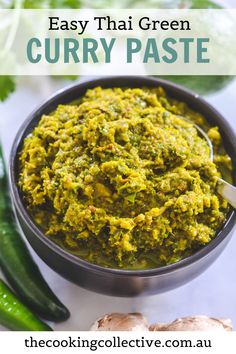 a bowl filled with curry paste next to green peppers and cucumber on the side