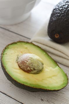 an avocado is cut in half on a table