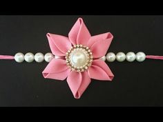 a pink flower with pearls on it