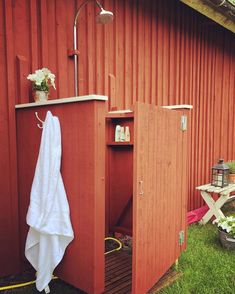 a red shed with a white towel hanging on it