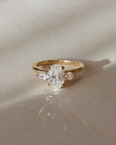 a gold ring with three diamonds on it