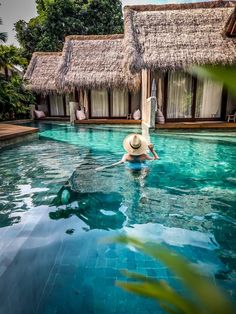 girl in swimming pool wearing big hat in front of accommodation in Bali Sunset Beaches, Bamboo Houses, Bingin Beach, Uluwatu Temple, Babymoon Destinations, Beach Clubs, Relax Spa, Babymoon