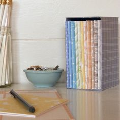 a desk with books, papers and a pen on it