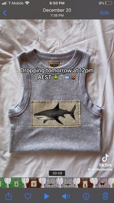 a shirt with an image of a shark on it and the words dropping tomorrow at 12pm