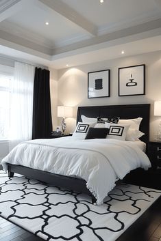 a bedroom with black and white decor on the walls, flooring and bedding