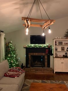 a living room filled with furniture and a fire place under a tv mounted above a fireplace