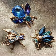 "Created in our studio, each of the bees are dimensional and ornamented with quality Swarovski crystal and vintage glass elements in shades of heliotrope, sapphire blue, indicolite turquoise, amethyst and starlight. Each has a safety catch pin back. Size: Largest Bee is 1.25\" L x 1.25\" W Smaller Bees are 1\" L x 1\" W Ready to gift, the set packaged in a velvet box Messengers of life's magic, these charming bee pins are offered in a set of three. Create a scatter pin statement along your neckl Bug Jewelry, Bee Sting, Vintage Bee