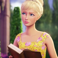 a barbie doll wearing a tiara and holding a book