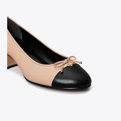 An elevated take on the classic ballet flat. This elegant pump is crafted in fine leather with a contrast cap toe and comfortable block heel. Finished with a delicate bow and subtle Double T.Crafted in partnership with a Leather Working Group-certified tannery, supporting high standards in leather manufacturing and chemical management.