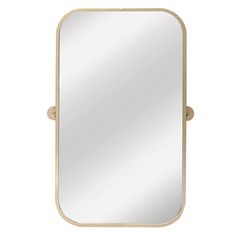 a gold framed mirror sitting on top of a white wall