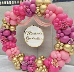 a pink and gold balloon wreath with the words miami's graduation written on it