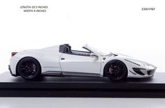 a white sports car is shown on a black stand