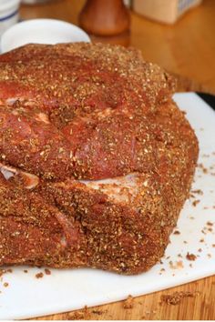 a large piece of meat sitting on top of a cutting board