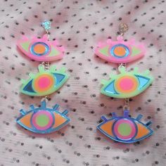 These awesome statement earrings are super colorful and fun! They're sure to upgrade your jewelry collection.*The design was laser cut from 1/8" inch thick acrylic.*The charms were cut from mirror blue, bright pink, sherbet, and frosted green acrylic.*Each earring contains three various color combinations.*They are lightweight, and were attached to a circular acrylic earring post with a surgical steel stud.*These can be personalized with earring posts, ear wire, or wrap around hooks for stretche Playful Bright Colored Jewelry Gift, Fun Neon Earrings For Gifts, Edgy Outfit, Weird Jewelry, Quirky Earrings, Acrylic Earring, Laser Cut Jewelry, Funky Earrings, Funky Jewelry