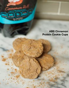 some cookies are on the counter next to a bottle