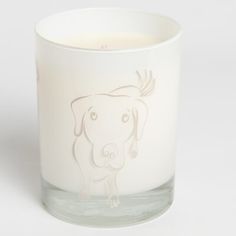 a glass candle with a drawing of a dog on it