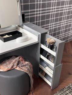 a white desk with a mirror, stool and other items