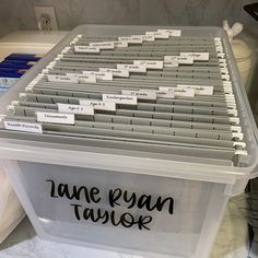 a plastic container filled with name tags on top of a counter