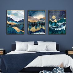 three paintings hang on the wall above a bed