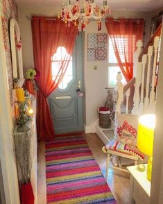 the hallway is decorated with colorful rugs and curtains, along with an entry door