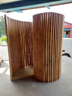 two wooden benches sitting next to each other in front of a white truck on the street