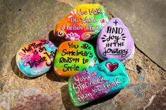 painted rocks with words and phrases on them